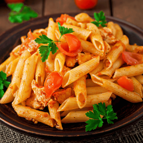 penne-pasta-tomato-sauce-with-chicken-tomatoes-wooden-table_2829-9791