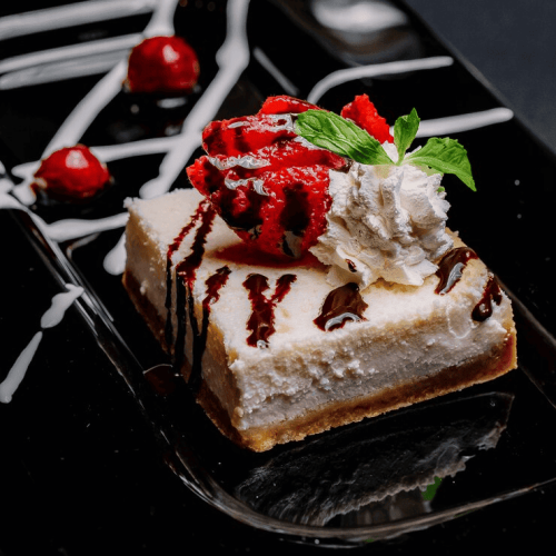 side-view-cheesecake-with-chocolate-whipped-cream-strawberry-mint-cherry-plate_141793-3610